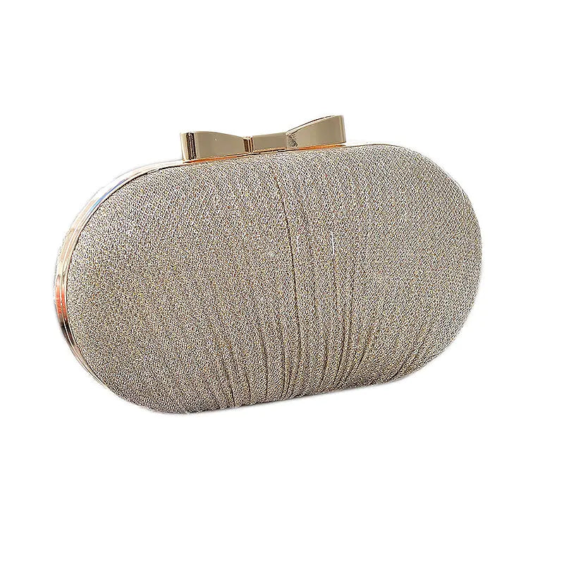 Bolso de mano de noche dorado con lazo metálico